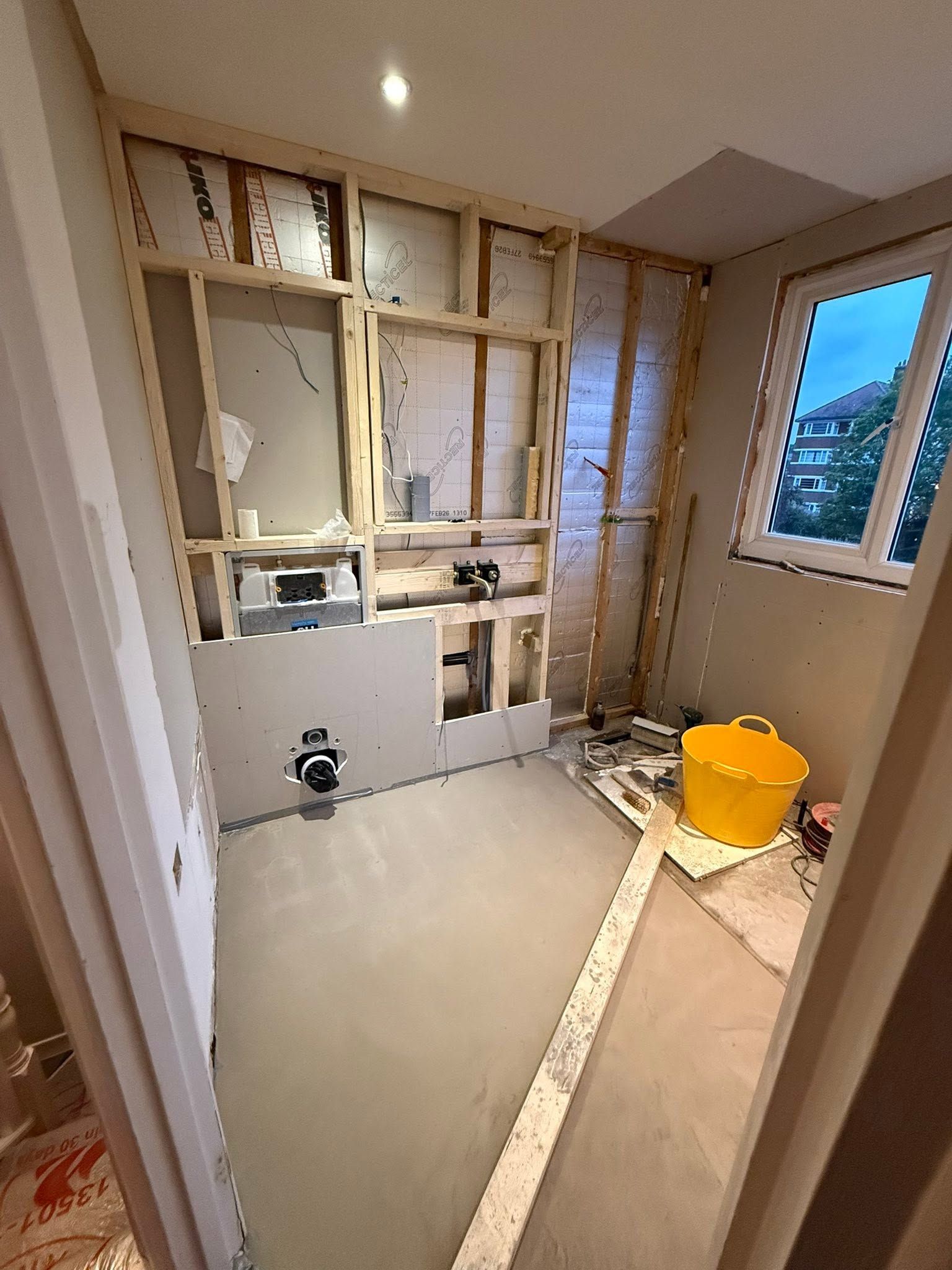 New stud walls, boarding and a concealed frame for a wall-hung toilet during first fix