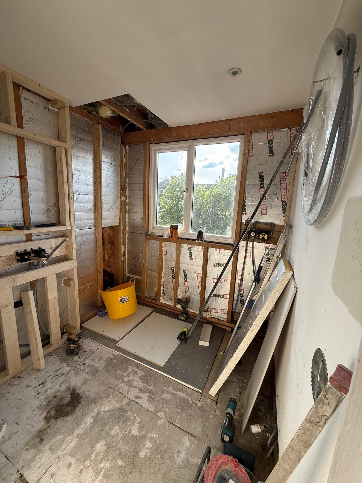 Bathroom stripped back to the timber studwork and insulation, ready for new pipework